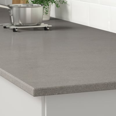A sleek, grey quartz countertop in a kitchen, showcasing its smooth, durable surface resistant to stains, scratches, and moisture.
