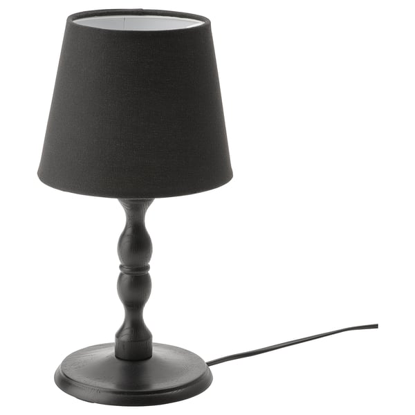 Black KINNAHULT table lamp with conical shade, wooden base, and cord, showcasing scandinavian craftsmanship.