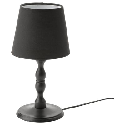 Black KINNAHULT table lamp with conical shade, wooden base, and cord, showcasing scandinavian craftsmanship.