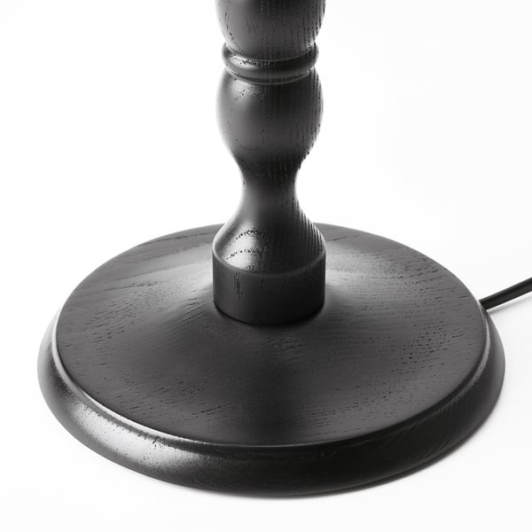 Black wooden lamp base, detailed with turned designs, sturdy and elegant.