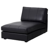Black leather KIVIK chaise, modern, curved, padded for comfort.