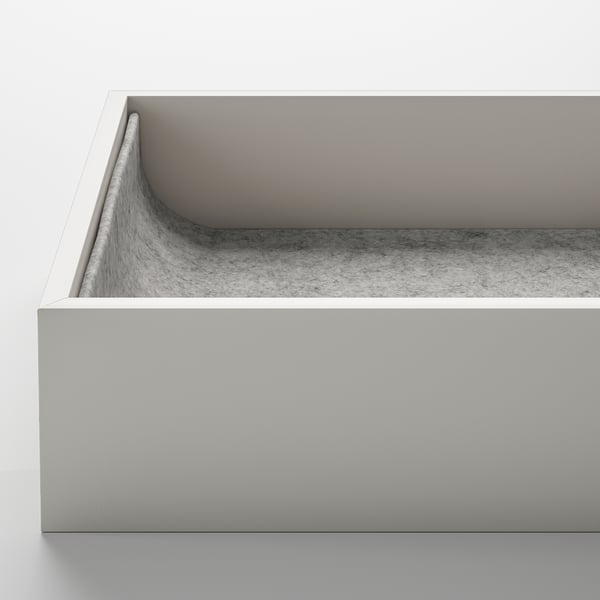Modern, minimalist white storage box with curved edges, soft fabric interior for protecting accessories.