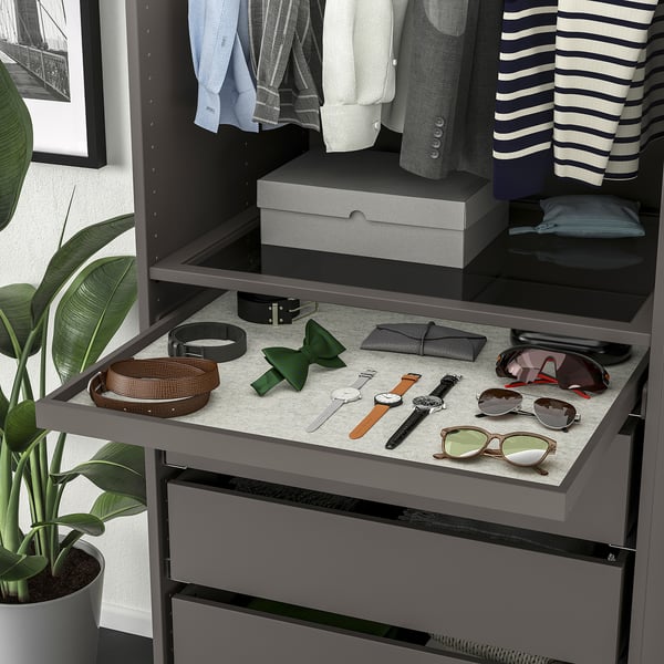 A wardrobe organiser with pull-out tray displaying accessories and clothes, ensuring easy access and visibility.