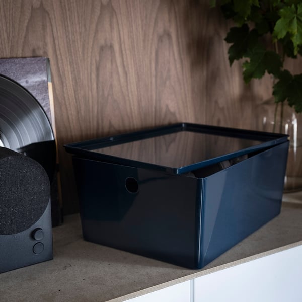 Dark blue storage box on a shelf, ideal for organising items and stacking.