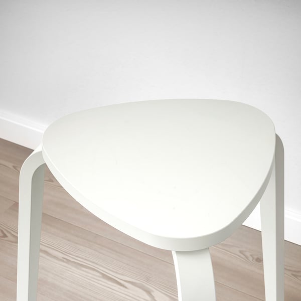 White, triangular stool with three sturdy legs, perfectly balanced with smooth surfaces.