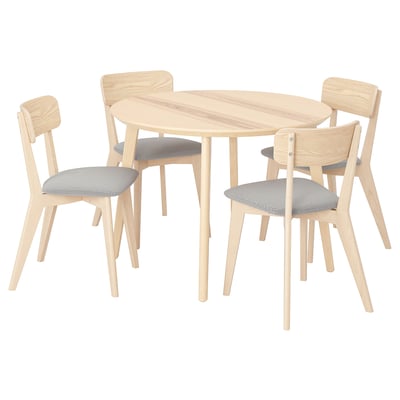 Wooden LISABO dining set with round table and 4 light chairs, padded in grey fabric.