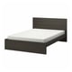 Modern dark wood MALM bed with white mattress, rectangular shape, clean design.