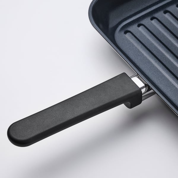 High-quality grill pan handle - ergonomic, non-slip grip, securely attached to robust stainless steel base.