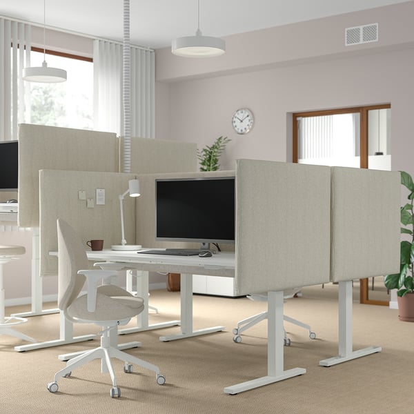 Modern office with MITTZON sit/stand desks, acoustic screens, and large windows.