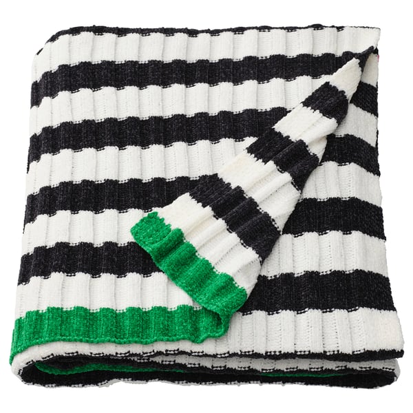 A MOSSMOTT throw blanket with black and white stripes and green accents, made from recycled polyester.