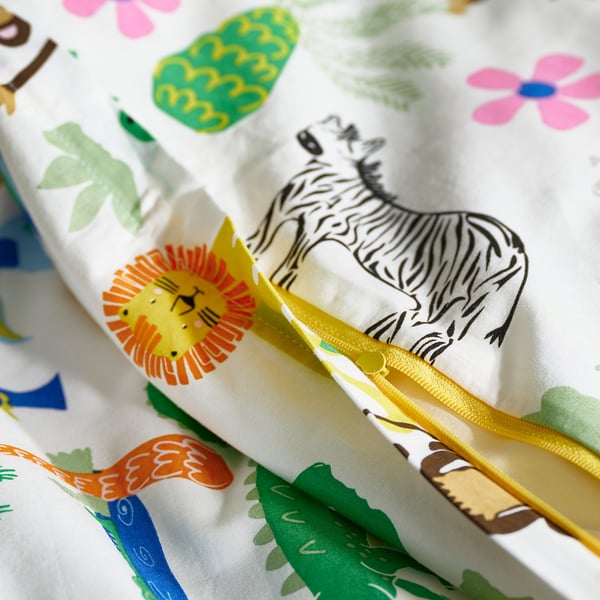 A colourful duvet with zebras, lions, and plants. Yellow ribbon zip keeps duvet secure.