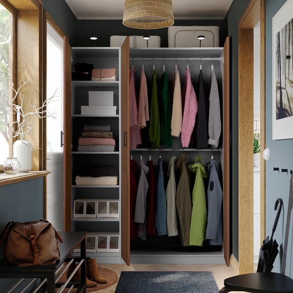 Well-organized walk-in closet with shelves and hanging space for clothes. Adjustable feet and integrated lighting.