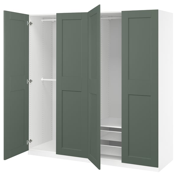 PAX wardrobe in green with open doors, showcasing shelves and storage.