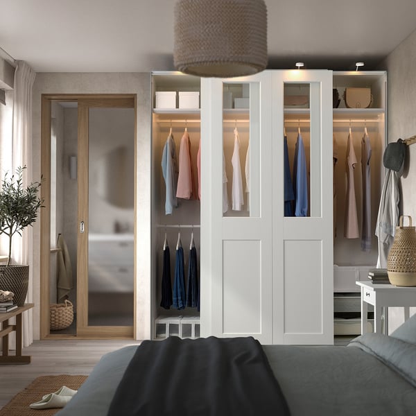 Modern bedroom with PAX wardrobe, bed, and balcony access.