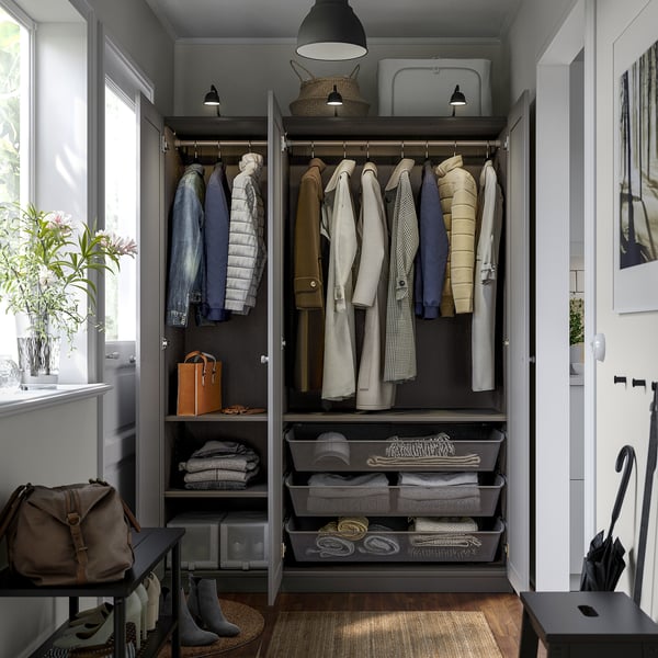 Organised closet with hanging coats, folded clothes, and accessories. Includes adjustable shelves and mesh baskets for storage.