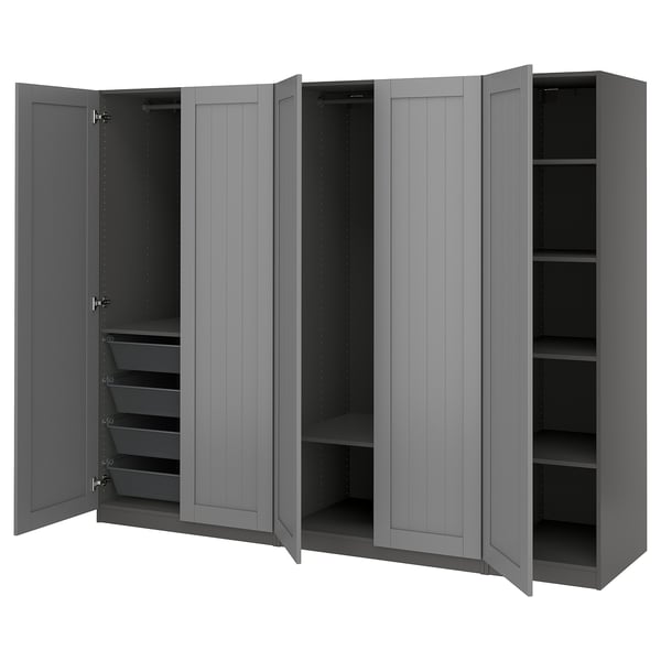 Grey PAX wardrobe with four open doors, displaying shelves and mesh baskets, mounted on the wall.
