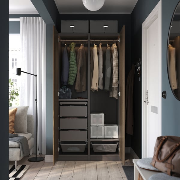 Modern wardrobe with hanging garments, drawers, and shelves. The hinges have dampers for slow, silent closure. Lighting and organisers are integrated.