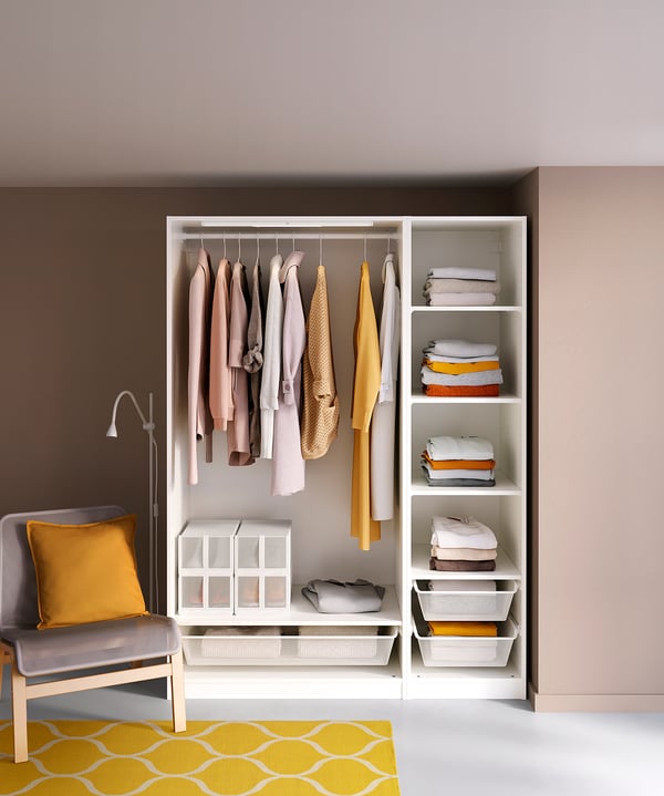 Neat closet with clothes and shelves. Yellow accents. Modern design.