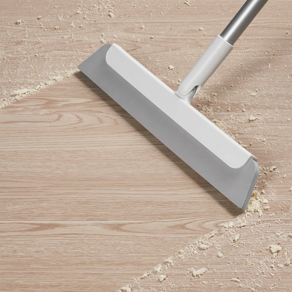 Floor squeegee with aluminium handle removes dirt and hair from floors.