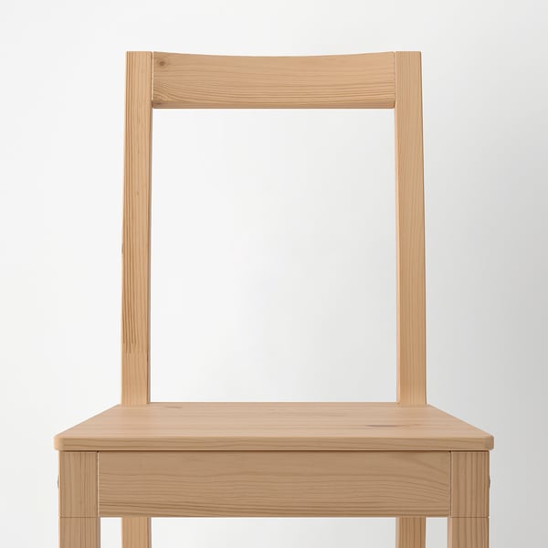 Minimalist wooden chair with angled back, wide seat. Pine, stained, lacquered. PINNTORP series, rustic feel.