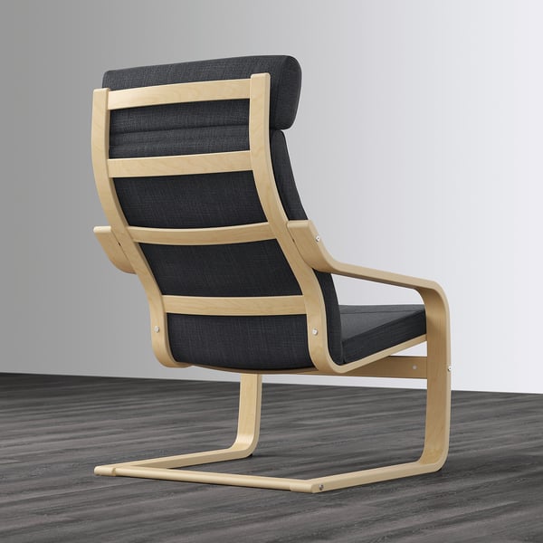 Black and light wood armchair with curved back for neck support. It sits on a wooden floor.