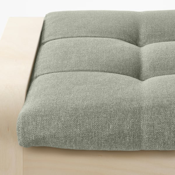 A close-up of a comfortable, textured grey fabric cushioned footstool with a sturdy wooden frame, designed for relaxation.