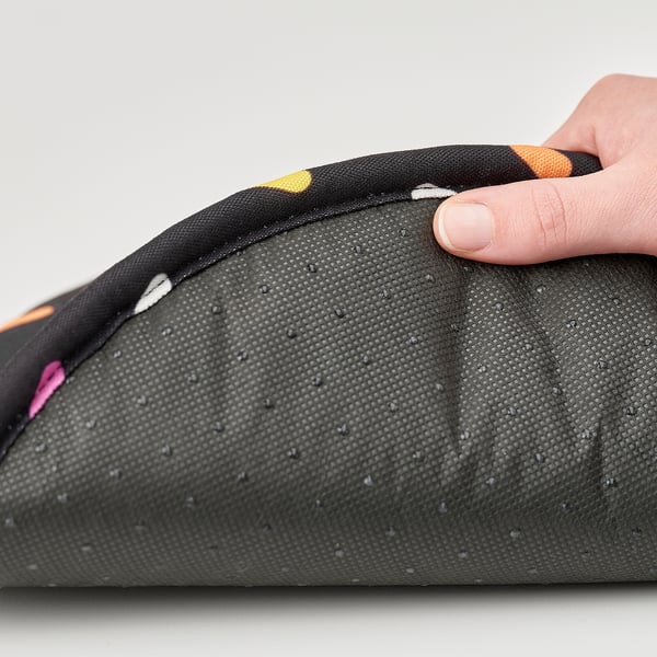 A hand zips a colourful, padded seat cushion with anti-slip bottom.