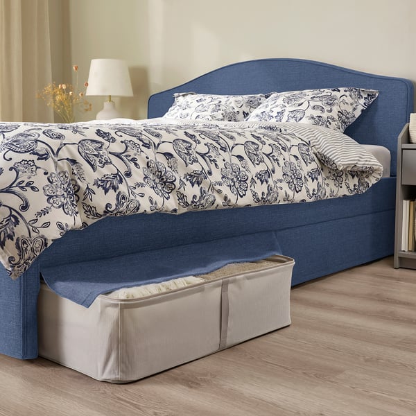 Bed with removable, machine-washable cover and padded headboard. Under-bed storage visible, ideal for organising items.