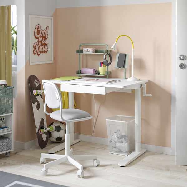 Neat home office: white adjustable desk with organiser, phone holder, and white chair. Modern, minimalist design.