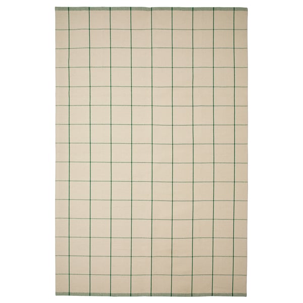 A rectangular RIDSTIG rug with a light beige background featuring green vertical stripes. It’s made of cotton and suitable for dining areas.