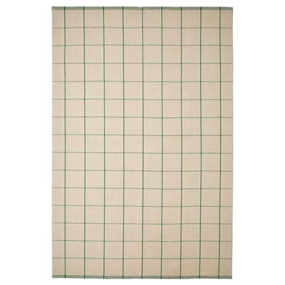 A rectangular RIDSTIG rug with a light beige background featuring green vertical stripes. It’s made of cotton and suitable for dining areas.