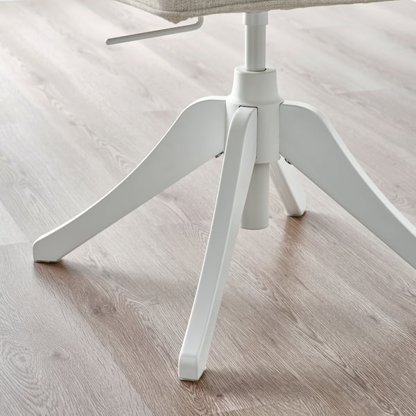 Modern white swivel office chair on light wooden floor, showcasing sturdy tripod legs and height adjustment mechanism.