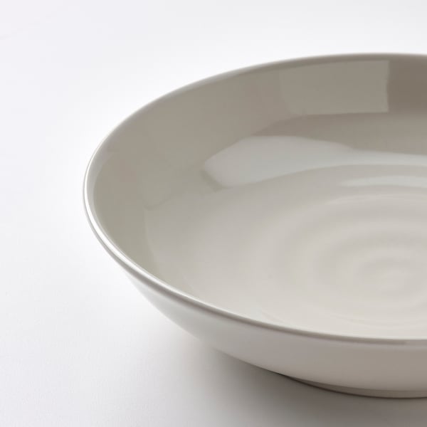 Smooth, cream-colored bowl with a glossy finish on a light background, showcasing its elegant, handcrafted texture.