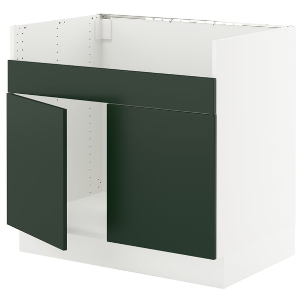 A SEKTION kitchen cabinet in white and green. It a modern design with flat panel doors and drawer fronts.