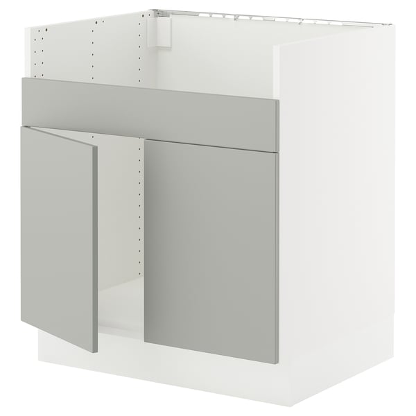 Modern white kitchen cabinet with grey doors and drawers. Sleek, flat-panel design featuring sturdy frame construction.