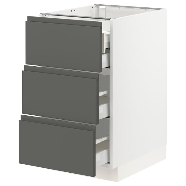 Modern kitchen cabinet in white with grey drawers. Sleek, integrated handles and high-quality material.