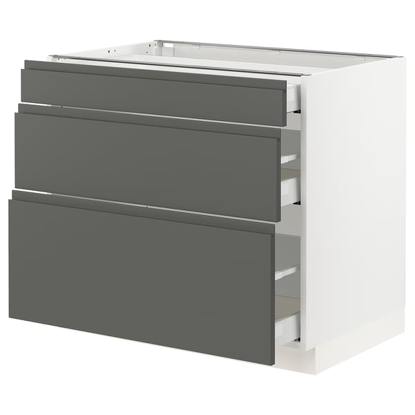 A modern, white kitchen cabinet with grey drawers. It has a sleek, rectangular design with integrated handles.