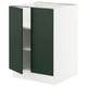 SEKTION kitchen cabinet in green with two open doors revealing adjustable shelves, white base.