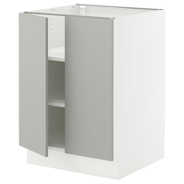 White kitchen cabinet from ikea with light grey door, two shelves, and adjustable hinges.