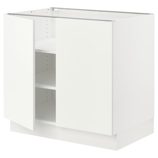 A white SEKTION base cabinet with no doors, designed for kitchen use. It has an adjustable shelf and a sturdy frame.