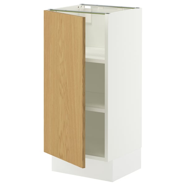 A white SEKTION kitchen cabinet with an oak door open, revealing adjustable shelves inside.