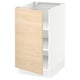An ikea SEKTION kitchen cabinet in white with a light ash wood door.