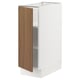 White SEKTION kitchen cabinet with walnut door, slightly ajar, adjustable shelves inside.