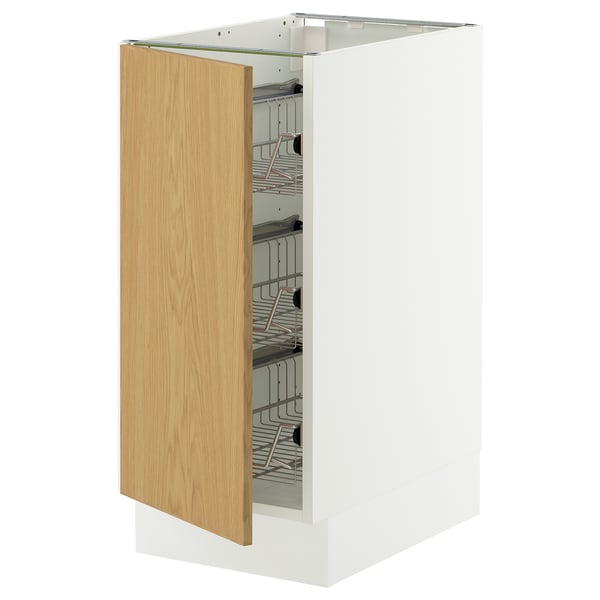 A white SEKTION kitchen cabinet with a light oak door partially open, revealing wire baskets inside.