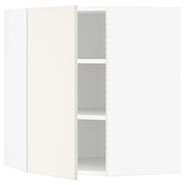 A white SEKTION corner kitchen cabinet with open doors, revealing adjustable shelves.