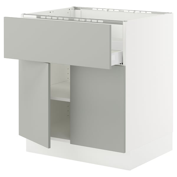 A light grey SEKTION kitchen cabinet with a modern design. It has a drawer with a built-in damper and an adjustable shelf.