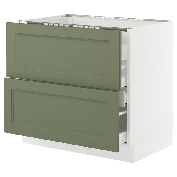 A SEKTION kitchen cabinet with two green-gray drawers and a white base. The design is modern with a classic touch.
