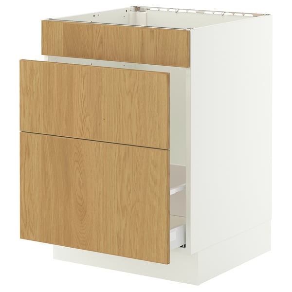 A white SEKTION cabinet with oak drawers. It has a modern design with clean lines and wooden panels on the front.