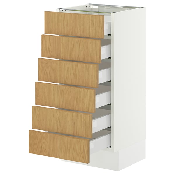 A white SEKTION cabinet with six wooden drawers, each featuring oak veneer and a smooth, full-extension design.