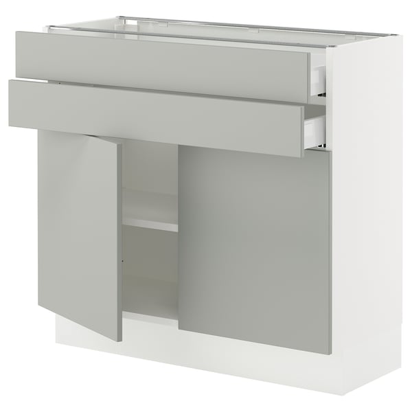 A SEKTION kitchen cabinet in light grey with an open drawer and shelf.